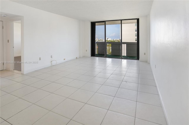 800 W Ave Unit 920, Miami Beach, FL 33139 - unfurnished room with expansive windows, light tile patterned flooring, and baseboards