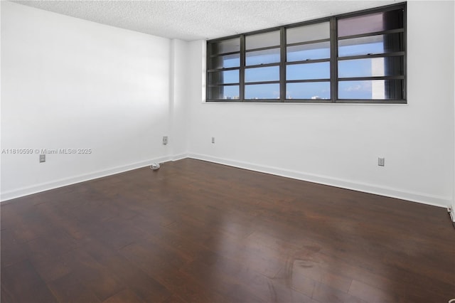 800 W Ave Unit 920, Miami Beach, FL 33139 - unfurnished room featuring a textured ceiling, wood finished floors, and baseboards
