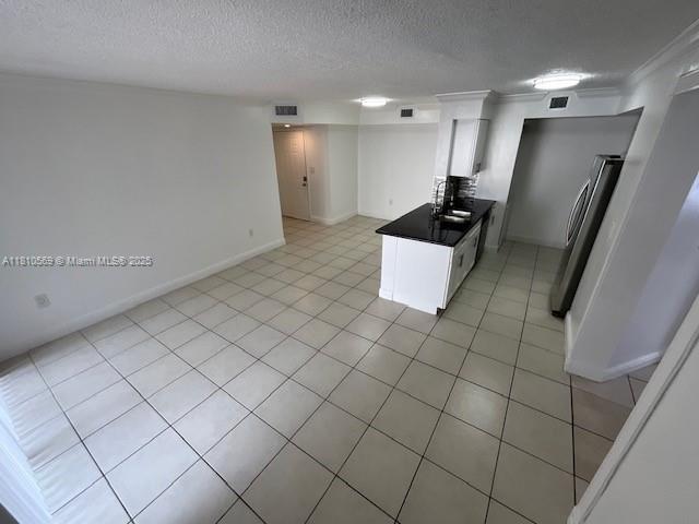 15221 SW 80th St Unit 201, Miami, FL 33193 - kitchen featuring a sink, white cabinets, dark countertops, refrigerator, and baseboards