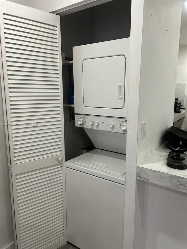 6095 W 19th Ave Unit 209, Hialeah, FL 33012 - laundry room with stacked washer and clothes dryer