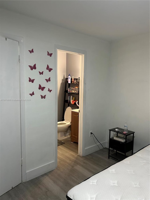 6095 W 19th Ave Unit 209, Hialeah, FL 33012 - bedroom with wood finished floors, baseboards, and ensuite bath