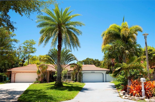1328 NW 93rd Ter, Coral Springs, FL 33071 - mediterranean / spanish-style house featuring an attached garage, concrete driveway, a tiled roof, stucco siding, and a front yard