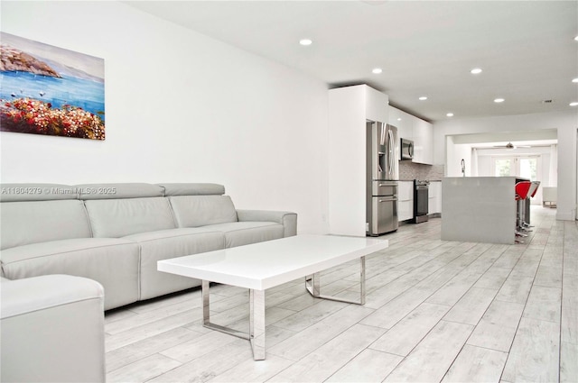 1328 NW 93rd Ter, Coral Springs, FL 33071 - living room with ceiling fan, light wood-style floors, and recessed lighting
