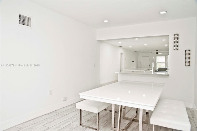 1328 NW 93rd Ter, Coral Springs, FL 33071 - unfurnished dining area with light wood-style flooring, recessed lighting, and baseboards