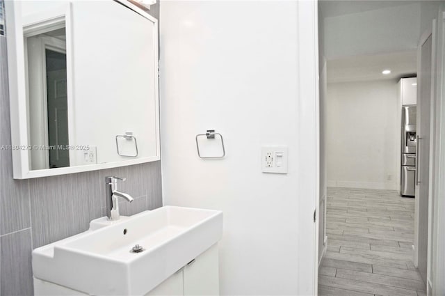 1328 NW 93rd Ter, Coral Springs, FL 33071 - bathroom featuring wood finished floors, vanity, and recessed lighting