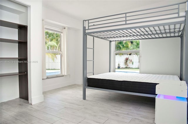 1328 NW 93rd Ter, Coral Springs, FL 33071 - bedroom with light wood finished floors and baseboards
