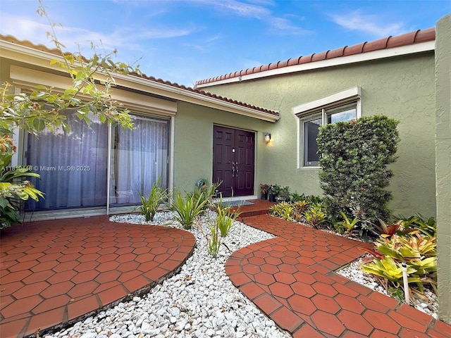 8923 SW 151st Ct, Miami, FL 33196 - view of exterior entry featuring stucco siding, a patio, and a tile roof