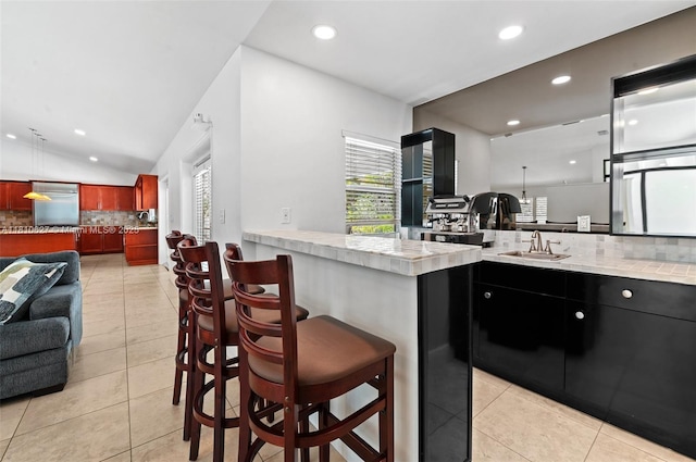 7350 SW 154th Ter, Palmetto Bay, FL 33157 - kitchen with backsplash, light countertops, a sink, light tile patterned flooring, and recessed lighting