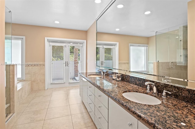 7350 SW 154th Ter, Palmetto Bay, FL 33157 - bathroom with a stall shower, double vanity, tile patterned floors, recessed lighting, and a wainscoted wall