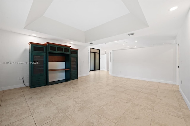 7350 SW 154th Ter, Palmetto Bay, FL 33157 - empty room with a raised ceiling, recessed lighting, baseboards, and light tile patterned floors