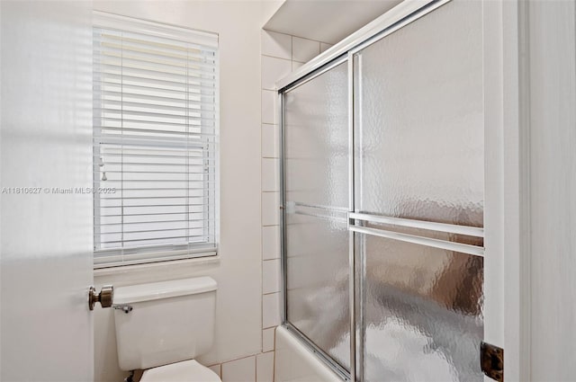 7350 SW 154th Ter, Palmetto Bay, FL 33157 - bathroom featuring combined bath / shower with glass door and toilet
