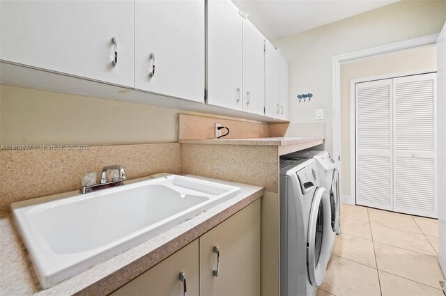 7350 SW 154th Ter, Palmetto Bay, FL 33157 - washroom featuring separate washer and dryer, cabinet space, and light tile patterned flooring