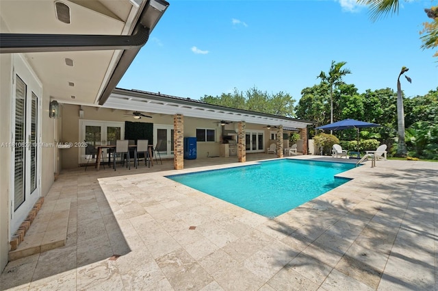 7350 SW 154th Ter, Palmetto Bay, FL 33157 - swimming pool with french doors, ceiling fan, a patio, and outdoor dining space