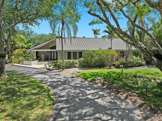 7350 SW 154th Ter, Palmetto Bay, FL 33157 - view of front of property with stucco siding, metal roof, a carport, and a front yard