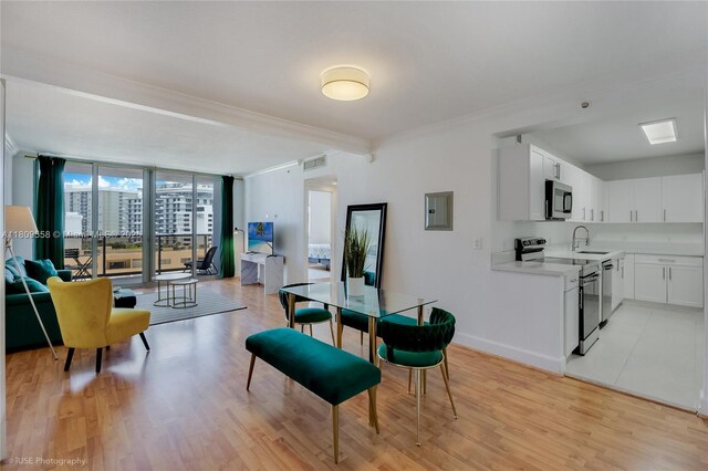 401 69th St Unit 708, Miami Beach, FL 33141 - dining room with ornamental molding, light wood-style floors, electric panel, and expansive windows