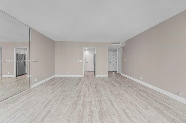 3700 Galt Ocean Dr Unit 1408, Fort Lauderdale, FL 33308 - unfurnished living room featuring light wood finished floors and baseboards