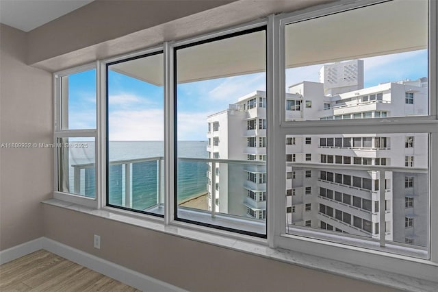 3700 Galt Ocean Dr Unit 1408, Fort Lauderdale, FL 33308 - empty room with baseboards, wood finished floors, and a water view