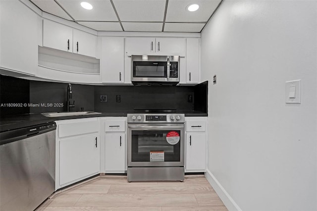 3700 Galt Ocean Dr Unit 1408, Fort Lauderdale, FL 33308 - kitchen with stainless steel appliances, dark countertops, a sink, white cabinetry, and recessed lighting