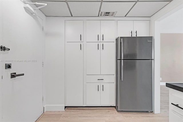 3700 Galt Ocean Dr Unit 1408, Fort Lauderdale, FL 33308 - kitchen with freestanding refrigerator, a paneled ceiling, white cabinetry, and light wood-style flooring