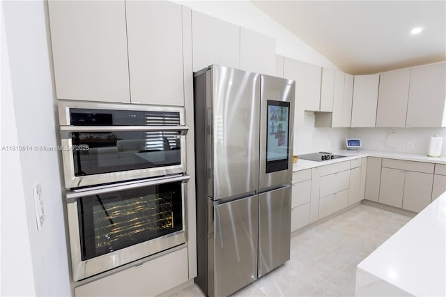 18781 SW 294th Ter, Homestead, FL 33030 - kitchen with appliances with stainless steel finishes, light countertops, lofted ceiling, light tile patterned floors, and backsplash