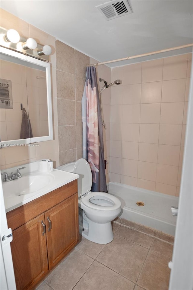 15610 NE 6th Ave Unit 22B, Miami, FL 33162 - full bath with tile patterned flooring, tile walls, vanity, a shower stall, and toilet