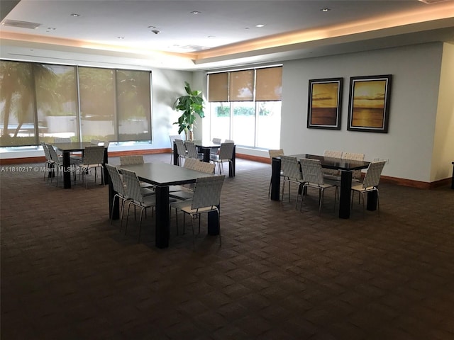 1060 Brickell Ave Unit 801, Miami, FL 33131 - dining area featuring a tray ceiling, dark colored carpet, baseboards, and recessed lighting