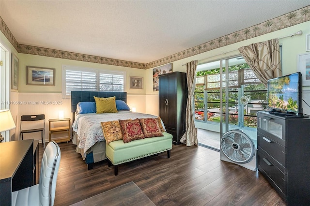 284 Prescott N Unit 284, Deerfield Beach, FL 33442 - bedroom featuring dark wood-style floors, a textured ceiling, access to outside, and a wainscoted wall