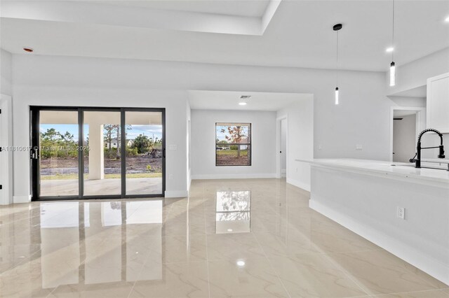 452 Mercedes Ct, Lehigh Acres, FL 33972 - empty room featuring light marble finish flooring, baseboards, recessed lighting, and a sink