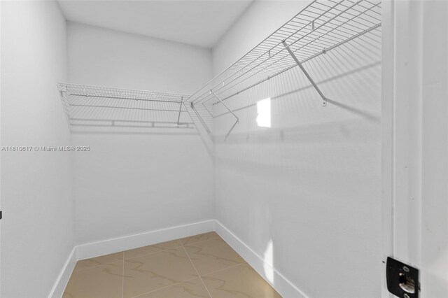 452 Mercedes Ct, Lehigh Acres, FL 33972 - walk in closet with light marble finish flooring