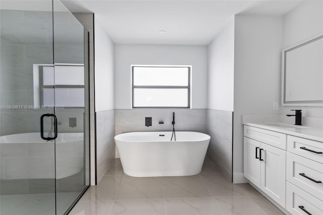452 Mercedes Ct, Lehigh Acres, FL 33972 - full bathroom with vanity, marble finish floors, a shower stall, and a freestanding tub
