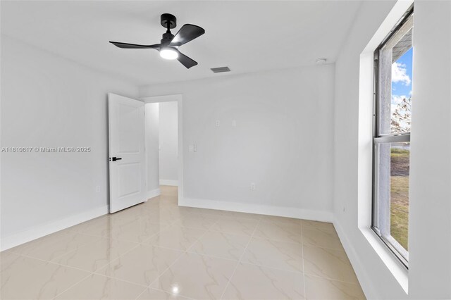 452 Mercedes Ct, Lehigh Acres, FL 33972 - spare room featuring baseboards and a ceiling fan