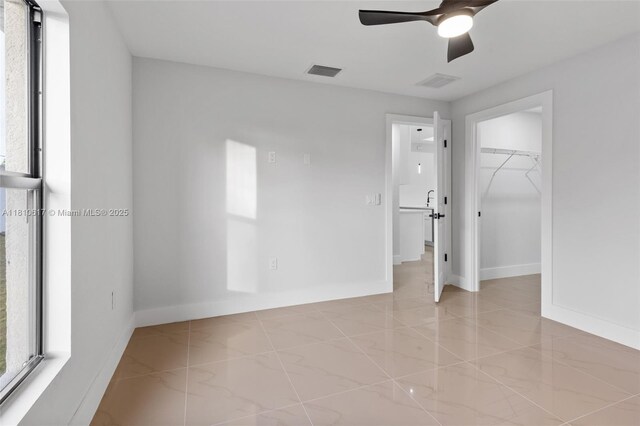 452 Mercedes Ct, Lehigh Acres, FL 33972 - unfurnished bedroom with baseboards, a walk in closet, marble finish flooring, a ceiling fan, and a closet