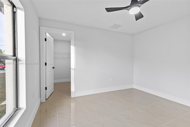 452 Mercedes Ct, Lehigh Acres, FL 33972 - empty room with light marble finish floors, baseboards, and ceiling fan