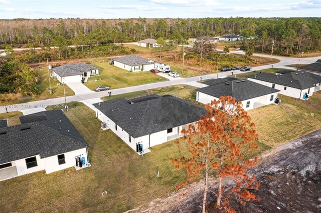 452 Mercedes Ct, Lehigh Acres, FL 33972 - aerial perspective of suburban area featuring a forest