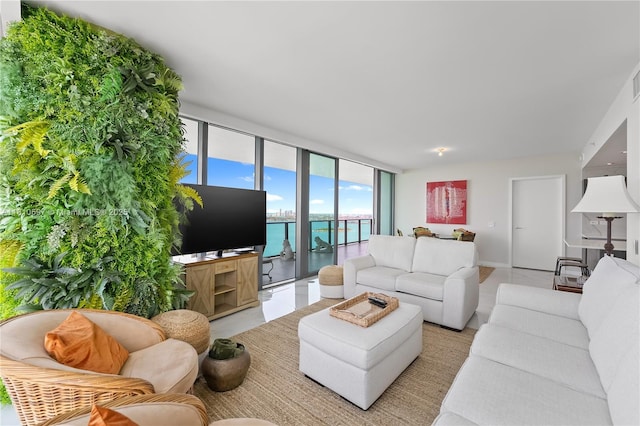 3131 NE 7th Ave Unit 3106, Miami, FL 33137 - living room featuring a wall of windows, light tile patterned floors, and baseboards