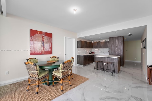 3131 NE 7th Ave Unit 3106, Miami, FL 33137 - dining area with baseboards and light marble finish floors