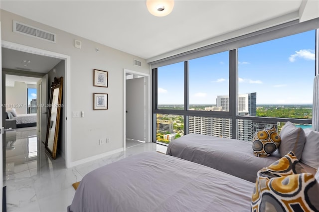 3131 NE 7th Ave Unit 3106, Miami, FL 33137 - bedroom featuring marble tiled flooring, multiple windows, baseboards, and expansive windows