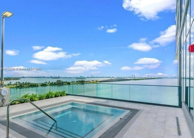 3131 NE 7th Ave Unit 3106, Miami, FL 33137 - view of swimming pool featuring a hot tub, a water view, and a pool
