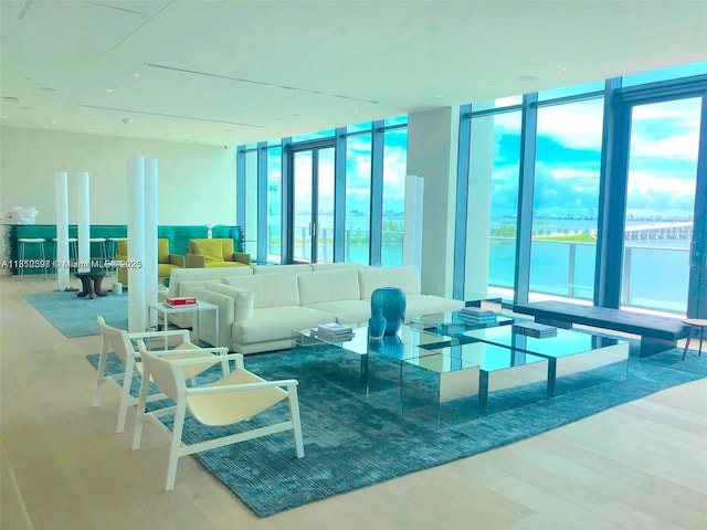 3131 NE 7th Ave Unit 3106, Miami, FL 33137 - living room featuring a wall of windows, wood finished floors, and a water view