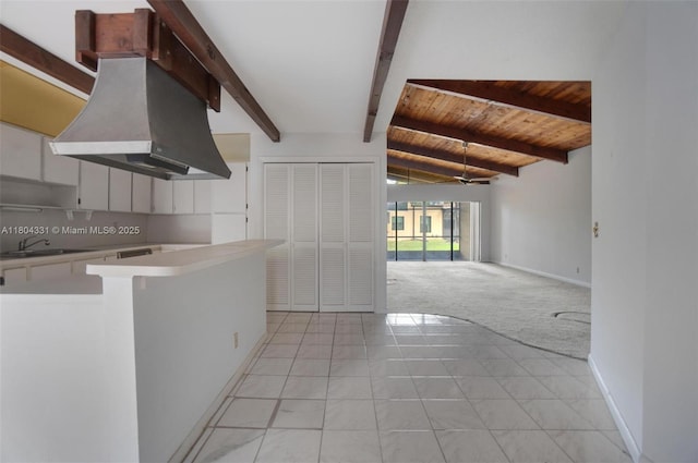 306 Cambridge Rd Unit 2-36, Hollywood, FL 33024 - kitchen featuring light countertops, a sink, light carpet, open floor plan, and wooden ceiling with exposed beams