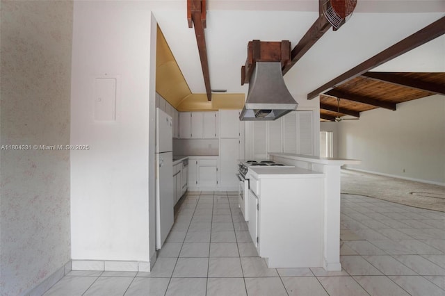 306 Cambridge Rd Unit 2-36, Hollywood, FL 33024 - kitchen with premium range hood, light countertops, freestanding refrigerator, white cabinetry, and light tile patterned floors