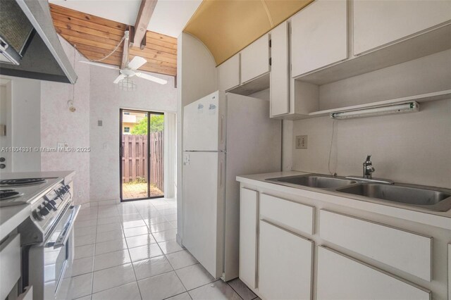 306 Cambridge Rd Unit 2-36, Hollywood, FL 33024 - kitchen with stainless steel electric range, under cabinet range hood, light tile patterned floors, light countertops, and beamed ceiling