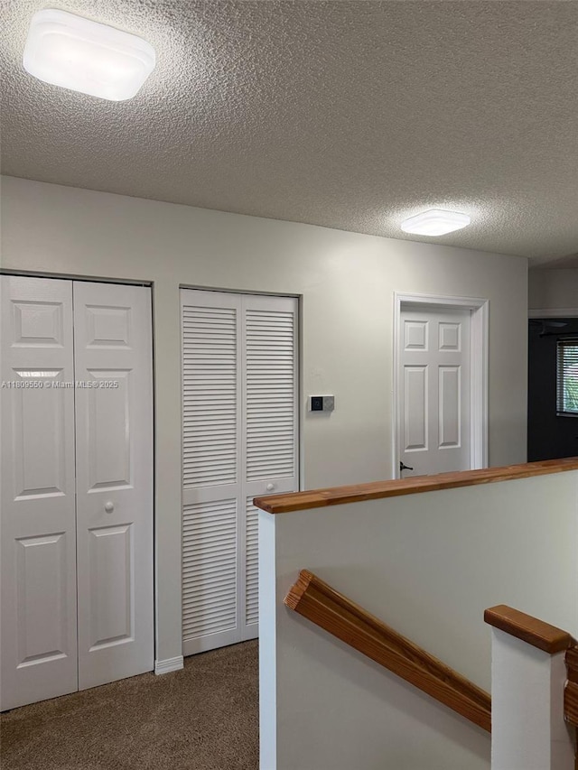 5552 NW 125th Ter, Coral Springs, FL 33076 - hall featuring an upstairs landing, carpet flooring, and a textured ceiling