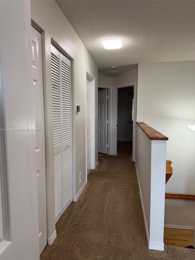 5552 NW 125th Ter, Coral Springs, FL 33076 - hallway featuring a textured ceiling, carpet floors, and baseboards
