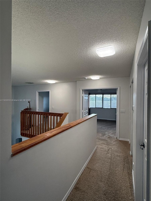 5552 NW 125th Ter, Coral Springs, FL 33076 - hallway featuring an upstairs landing, carpet flooring, a textured ceiling, and baseboards