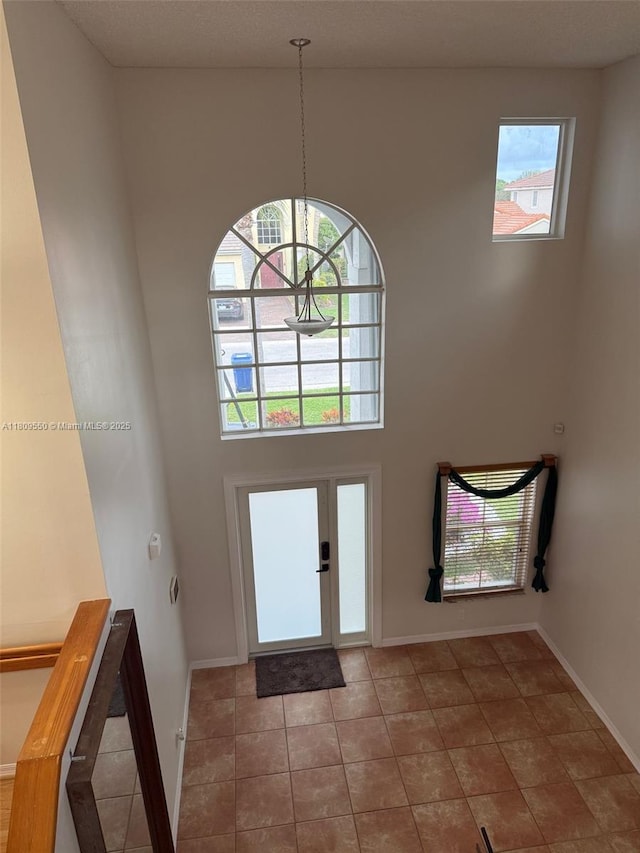 5552 NW 125th Ter, Coral Springs, FL 33076 - foyer entrance with plenty of natural light, a high ceiling, baseboards, and tile patterned floors