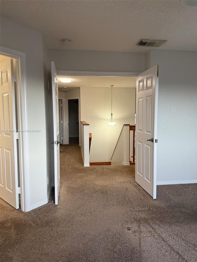 5552 NW 125th Ter, Coral Springs, FL 33076 - corridor with an upstairs landing, carpet, a textured ceiling, and baseboards