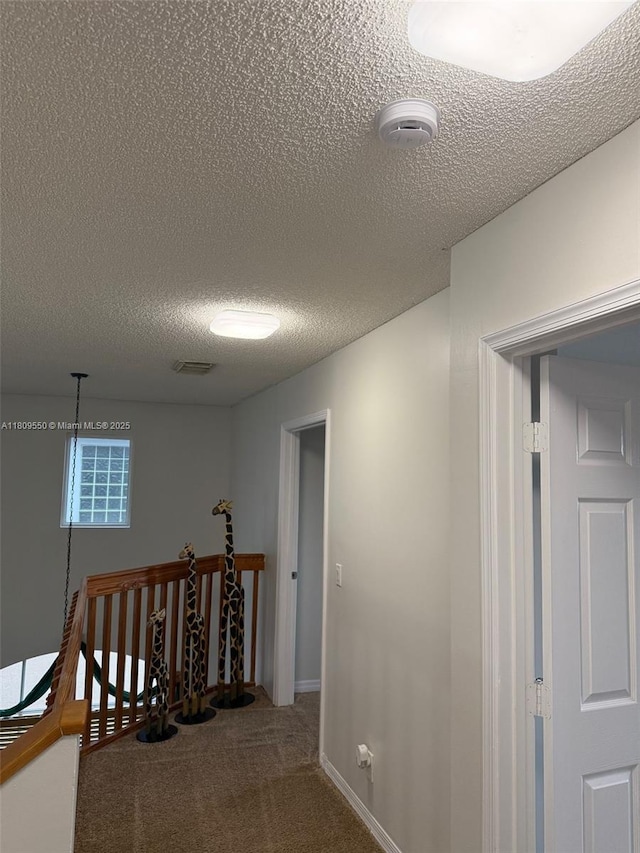5552 NW 125th Ter, Coral Springs, FL 33076 - hall featuring a textured ceiling, carpet floors, and an upstairs landing