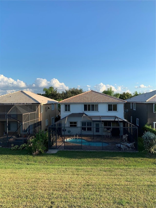 5552 NW 125th Ter, Coral Springs, FL 33076 - rear view of house featuring a lawn, a patio, an outdoor pool, glass enclosure, and a tiled roof