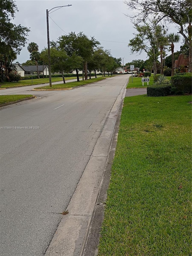 1302 Nebraska Ave Unit 1, Fort Pierce, FL 34950 - view of asphalt street with curbs and street lights